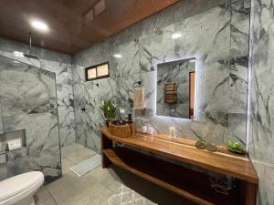 a bathroom with a sink and a mirror at Althi Mountain House in Naranjito +27 photos