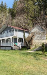 a large white house with a stone wall at Mountain apartments in Usteriki