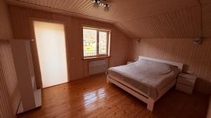 a bedroom with a bed in a room with a window at Mountain apartments in Usteriki +11 photos