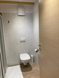 a bathroom with a toilet and a toilet paper dispenser at Il moleta affittacamere in Balbido-rango