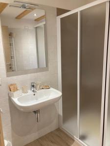 a bathroom with a sink and a shower at Il moleta affittacamere in Balbido-rango