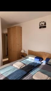 a bedroom with a large bed with blue sheets at Il moleta affittacamere in Balbido-rango
