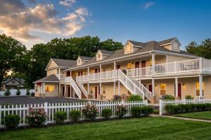 a large house with a white fence at At 9 Motel Near Freehold I-195 in Howell