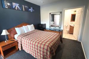 a hotel room with a bed and a mirror at At 9 Motel Near Freehold I-195 in Howell