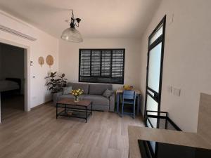 a living room with a couch and a table at נופי דפנה in Dafna