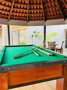 a pool table with cuesticks on top of it at WS Hotel in Campo Alegre +45 photos