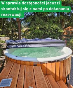 a jacuzzi tub on a wooden deck with a quote at Domki Anastazewo in Anastazewo