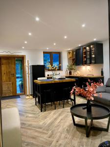 a kitchen and living room with a couch and a table at l atelier in Bozel