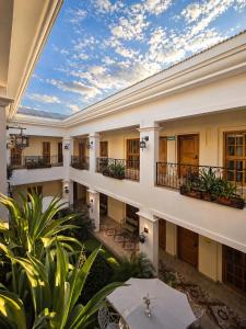 an indoor courtyard of a large building with plants at GRAN HOTEL VICTORIA in Rivas