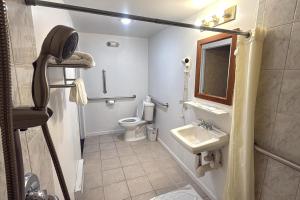 a small bathroom with a toilet and a sink at At 9 Motel Near Freehold I-195 in Howell
