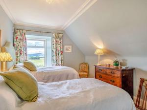 a bedroom with two beds and a window at 4 Bed in Huntly oc-88855 in Inverurie