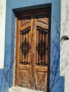 a wooden door on the side of a building at Rosie's Garden in Bocairent