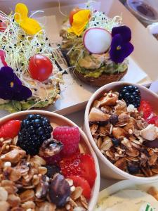 a table topped with bowls of food with fruit at Rosie's Garden in Bocairent