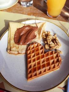 a plate with a heart shaped waffles and a waffleasy at Rosie's Garden in Bocairent +11 photos