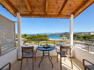 a patio with a table and chairs on a balcony at Vila Bilali in Ksamil