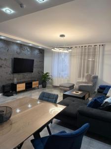 a living room with a couch and a table at Modern Apart in Wałbrzych