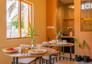two tables in a kitchen with food on them at Sansara Maldives - The Untouched South, Easy Access via Sri Lanka in Meedhoo