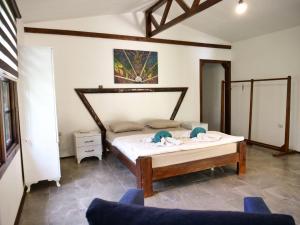 a bedroom with a bed and two blue chairs at Kidrak Camping NAMASTE in Faralya