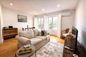 a living room with a couch and a tv at Cc House Porto in Porto