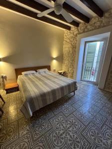 a bedroom with a large bed and a large window at Campet50 in Felanitx