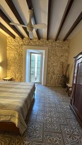 a bedroom with a bed and a stone wall at Campet50 in Felanitx