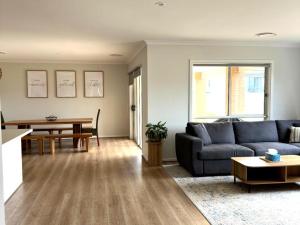a living room with a couch and a table at Nagambie Lakes in Nagambie