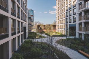 an empty courtyard between two tall buildings at Apartamenty Nowy Port by 2HomeRent in Bydgoszcz