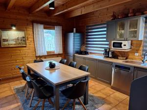 a kitchen with a table and chairs in a room at Logarska koča in Fokovci