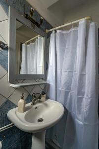 a bathroom with a sink and a mirror at Kythaeri Studios in Frátsia +44 photos
