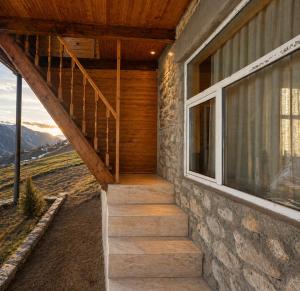 a staircase leading up to a house with a window at Guest house River side in Adishi