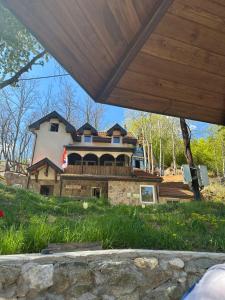 a large house on a hill in front of a house at Kuca za odmor ,,Balkan” in Crni Vrh