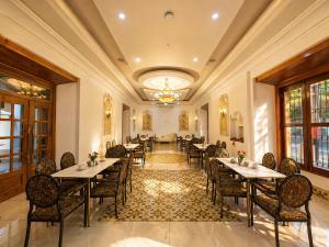 a restaurant with tables and chairs and a chandelier at GRAN HOTEL VICTORIA in Rivas