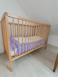 a wooden crib sitting in a room at Charmes à Changey in Changey