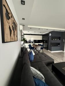 a living room with a couch and a table at Modern Apart in Wałbrzych