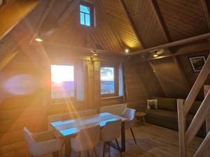 a room with a table and chairs and a couch at Apartamenty SKUPNIOWY UPŁAZ in Murzasichle
