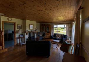 a living room with a couch and a table at Lakehouse Waterville in Waterville