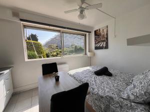 a bedroom with a bed and a window at La Studette Marina 06 in Villeneuve-Loubet