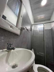 a bathroom with a sink and a shower and a toilet at 301ElBunkerSuiteRomance in Arauca +20 photos