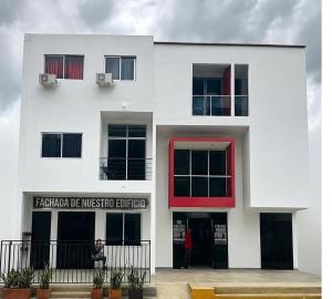 a white building with a red window at 301ElBunkerSuiteRomance in Arauca