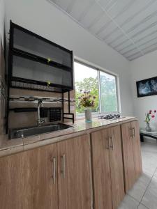 a kitchen with a sink and a large window at 301ElBunkerSuiteRomance in Arauca