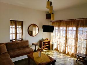 a living room with a couch and a table at VintageVilla in Skala Marion