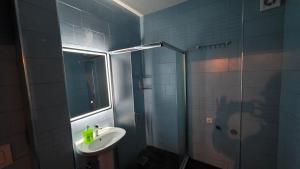 a bathroom with a sink and a shower at Art Apartment in Prizren +9 photos