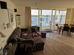 a living room with a couch and a view of the ocean at Ferienwohnung Austernfischer Marina Wendtorf in Wendtorf +45 photos