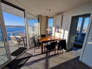 a dining room with a table and chairs on a balcony at Ferienwohnung Austernfischer Marina Wendtorf in Wendtorf