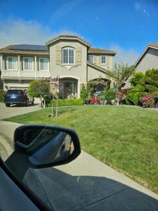 a side view mirror of a car in front of a house at Gateway to Napa in Fairfield