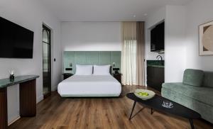 a hotel room with a bed and a couch at Zea Urban Living in Piraeus +26 photos