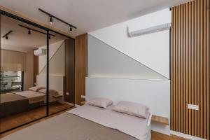 a bedroom with a bed and a glass wall at Luxury Apartment Bar in Šušanj
