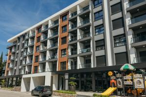 an apartment building with a car parked in front at Luxury Apartment Bar in Šušanj