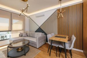 a living room with a couch and a table at Luxury Apartment Bar in Šušanj