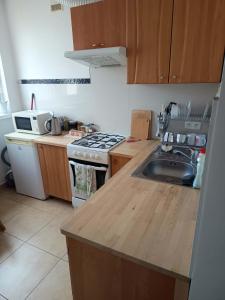 a kitchen with a sink and a stove top oven at Apartament Kościelna, dwie oddzielne sypialnie in Białystok +17 photos